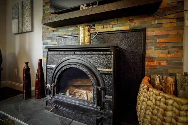597 Fisher Rd, Dartmouth, MA 02747 - detailed view of baseboards and a wood stove