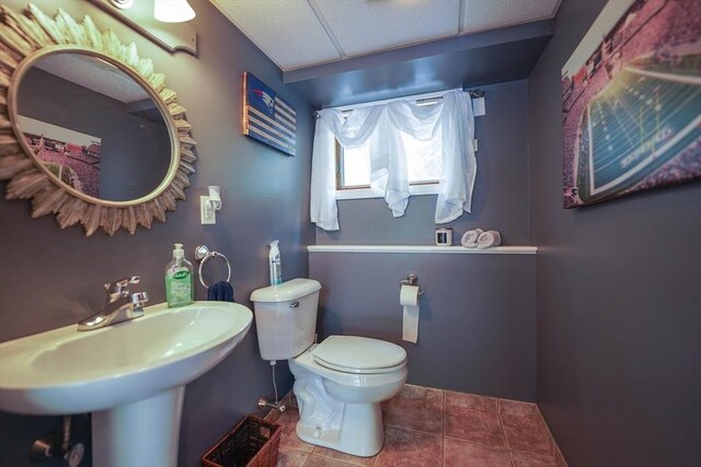 597 Fisher Rd, Dartmouth, MA 02747 - half bathroom with toilet, tile patterned flooring, a sink, and baseboards