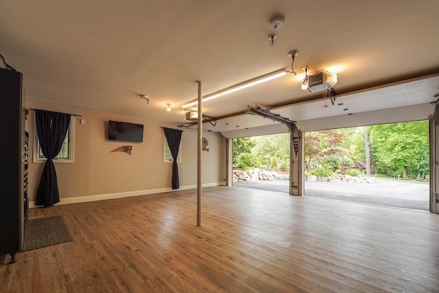 597 Fisher Rd, Dartmouth, MA 02747 - garage featuring a garage door opener and baseboards