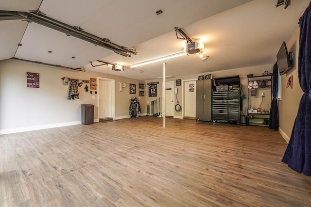 597 Fisher Rd, Dartmouth, MA 02747 - garage featuring a garage door opener and baseboards