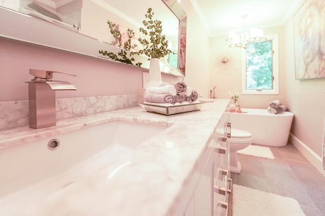 597 Fisher Rd, Dartmouth, MA 02747 - full bath with ornamental molding, a freestanding bath, double vanity, a chandelier, and toilet