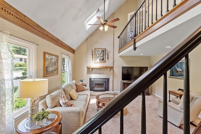 3 Sycamore Dr, Rutland, MA 01543 - carpeted living area with a ceiling fan, high vaulted ceiling, a brick fireplace, and a skylight