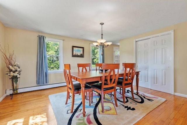 3 Sycamore Dr, Rutland, MA 01543 - dining space with a baseboard heating unit, light wood-style flooring, and a chandelier