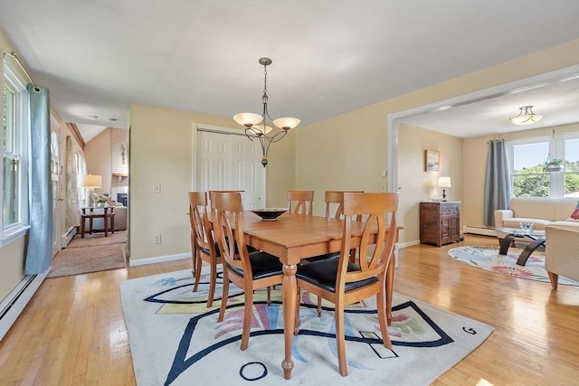 3 Sycamore Dr, Rutland, MA 01543 - dining space featuring light wood finished floors, a baseboard heating unit, and a chandelier