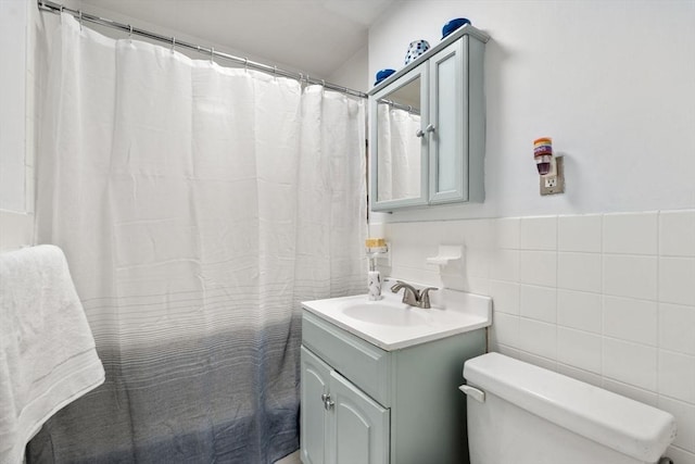 15 University Unit 32, Brookline, MA 02445 - bathroom with vanity, tile walls, and a wainscoted wall