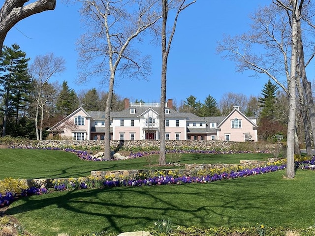 rear view of house with a lawn