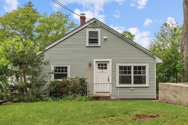 5 London Rd, Salem, NH 03079 - back of house with a chimney and a lawn