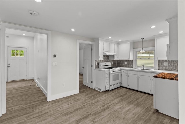 5 London Rd, Salem, NH 03079 - kitchen featuring white gas range, a sink, under cabinet range hood, light wood-style floors, and healthy amount of natural light