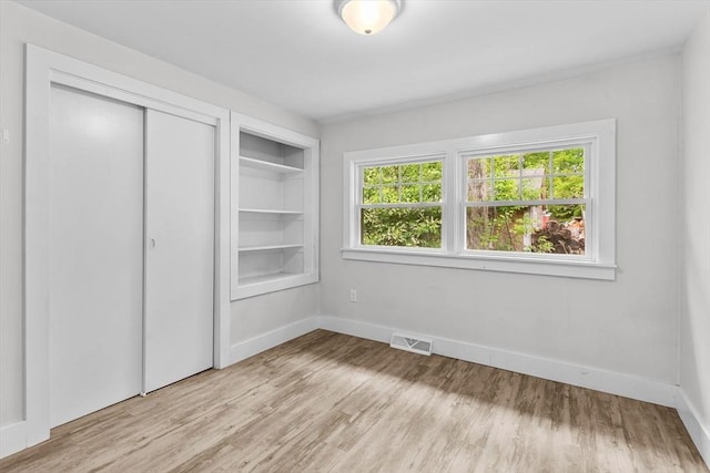 5 London Rd, Salem, NH 03079 - unfurnished bedroom with light wood-style floors, a closet, and baseboards