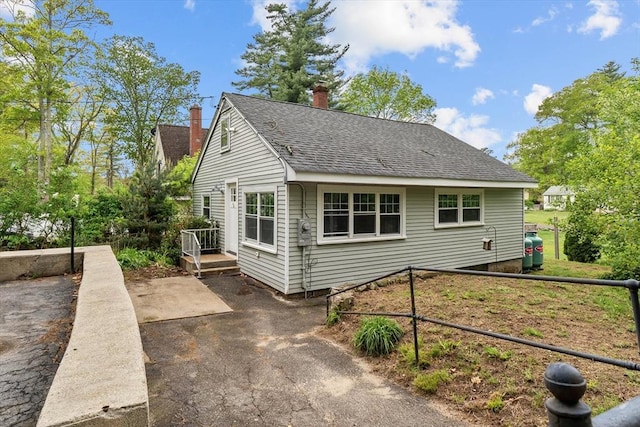 5 London Rd, Salem, NH 03079 - view of front of home with a chimney and a shingled roof