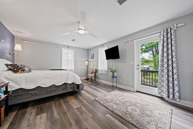 bedroom featuring wood finished floors, access to exterior, baseboards, visible vents, and a ceiling fan