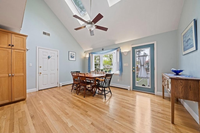 dining area with a baseboard heating unit, light wood finished floors, high vaulted ceiling, visible vents, and a baseboard radiator