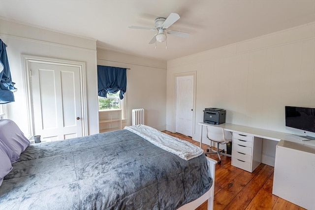 bedroom with radiator heating unit, ceiling fan, and hardwood / wood-style flooring