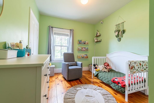 bedroom featuring light wood-type flooring and baseboards
