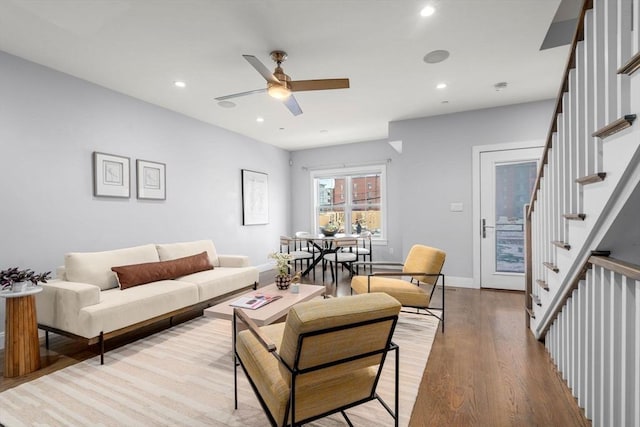 living room featuring ceiling fan and light hardwood / wood-style floors