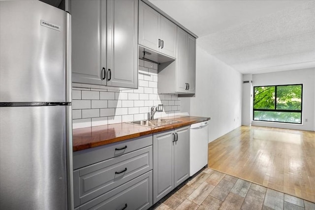 14 Heron St Unit 209, Boston, MA 02132 - kitchen featuring freestanding refrigerator, gray cabinets, white dishwasher, butcher block countertops, and a textured ceiling