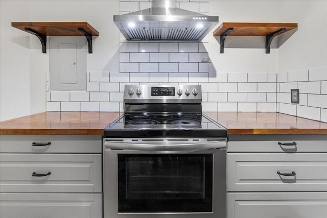 14 Heron St Unit 209, Boston, MA 02132 - kitchen with stainless steel range with electric stovetop, wall chimney range hood, wood counters, and open shelves