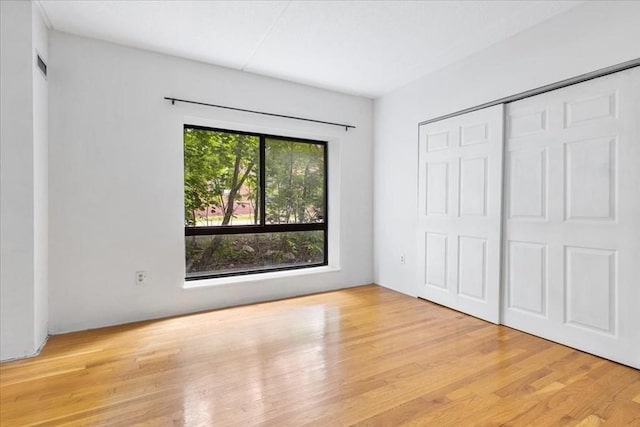 14 Heron St Unit 209, Boston, MA 02132 - unfurnished bedroom with wood finished floors and a closet