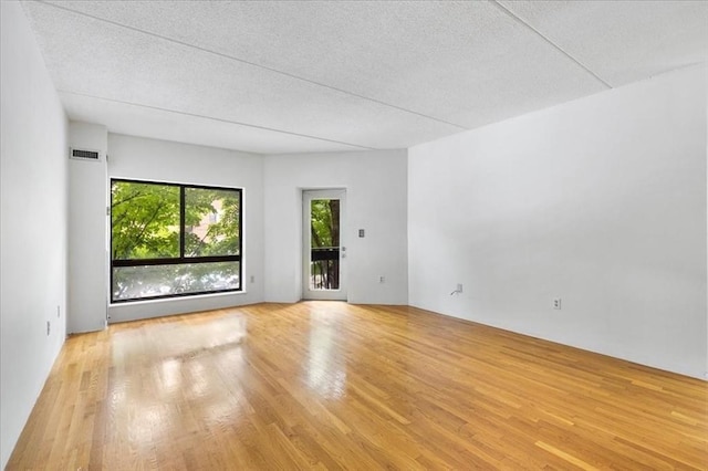 14 Heron St Unit 209, Boston, MA 02132 - empty room featuring wood finished floors and a textured ceiling