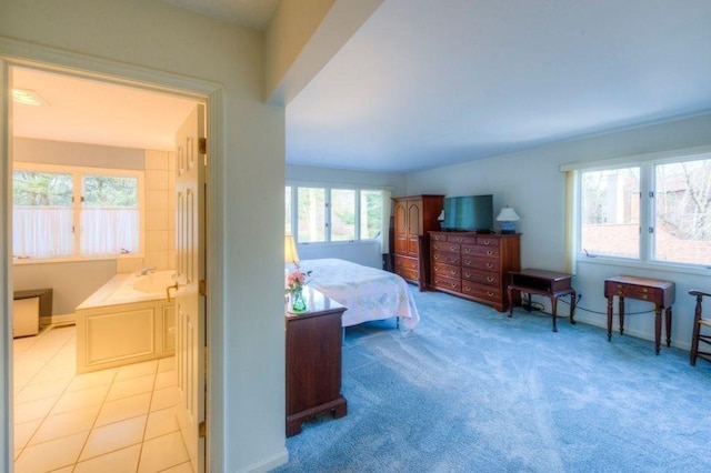 carpeted bedroom featuring sink and multiple windows