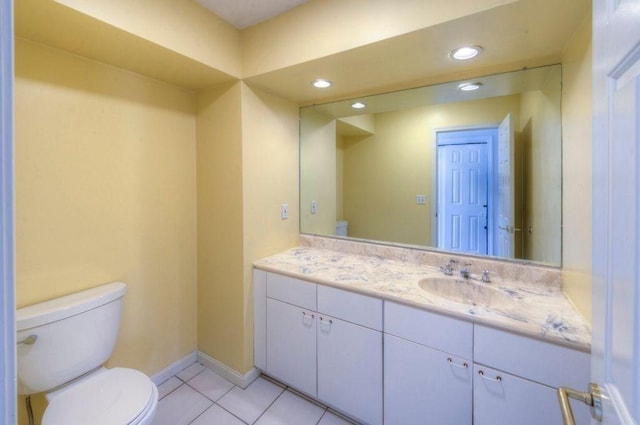 bathroom featuring tile patterned floors, vanity, and toilet