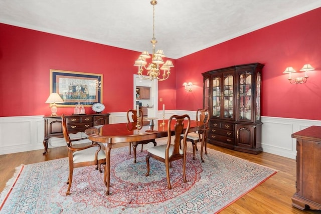 dining space featuring light hardwood / wood-style flooring and a chandelier