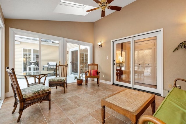 sunroom featuring ceiling fan and lofted ceiling with skylight