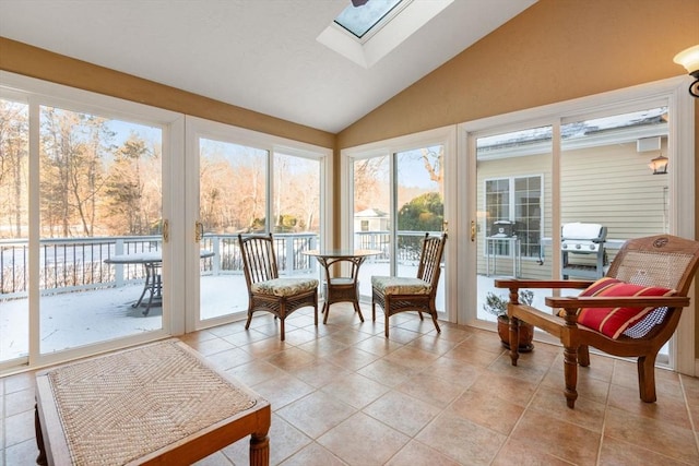 sunroom featuring lofted ceiling with skylight