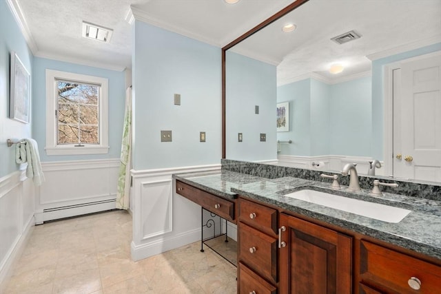 bathroom with a baseboard radiator, ornamental molding, and vanity