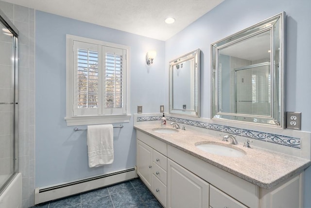 bathroom with vanity, a baseboard heating unit, tile patterned floors, and shower / bath combination with glass door