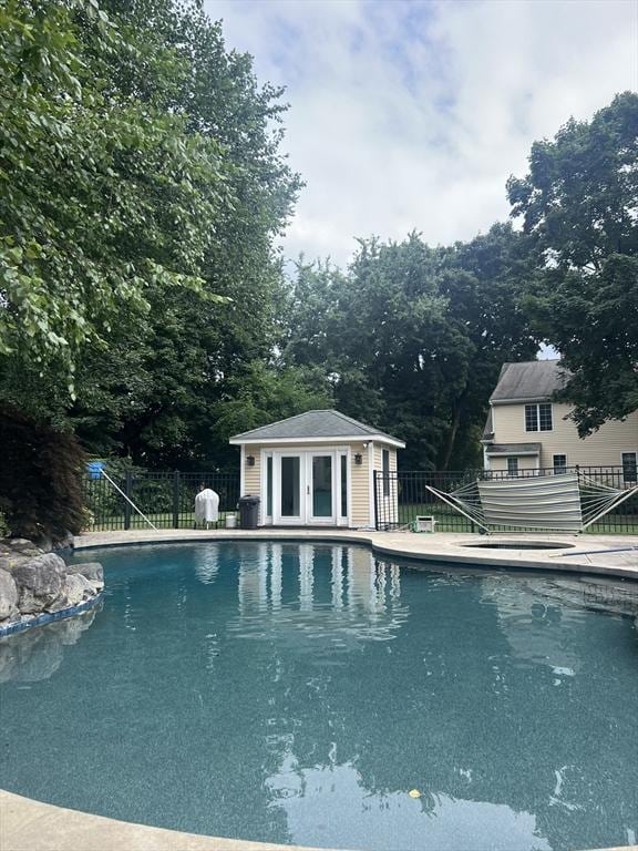 view of swimming pool with an outdoor structure