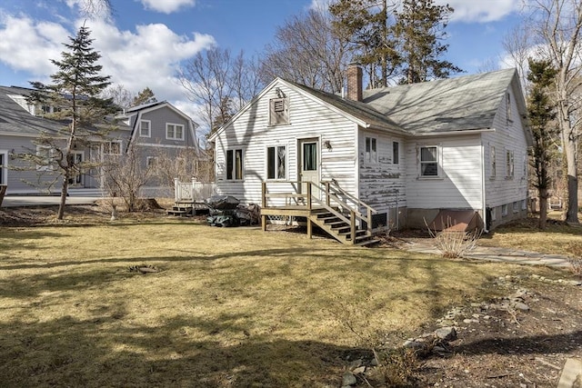 rear view of property featuring a yard and a chimney