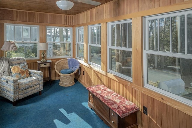 sunroom with wooden ceiling and ceiling fan