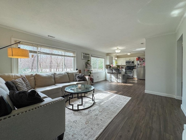 living area featuring dark wood-style floors, crown molding, visible vents, a textured ceiling, and baseboards