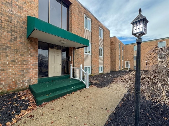 exterior space featuring brick siding