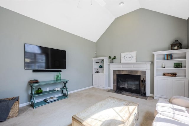 carpeted living room featuring baseboards, a ceiling fan, lofted ceiling, and a fireplace