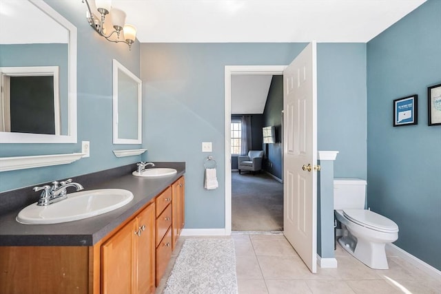 full bath featuring baseboards, a sink, and tile patterned flooring