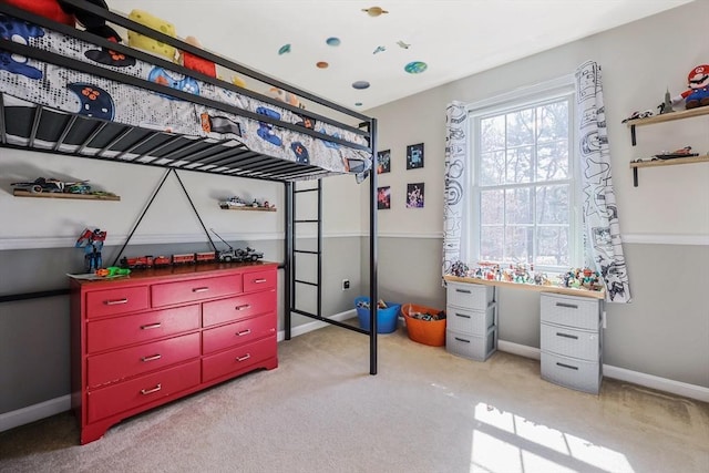 bedroom featuring baseboards and light carpet