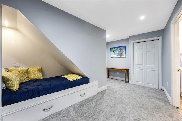 carpeted bedroom with baseboards, a closet, and recessed lighting