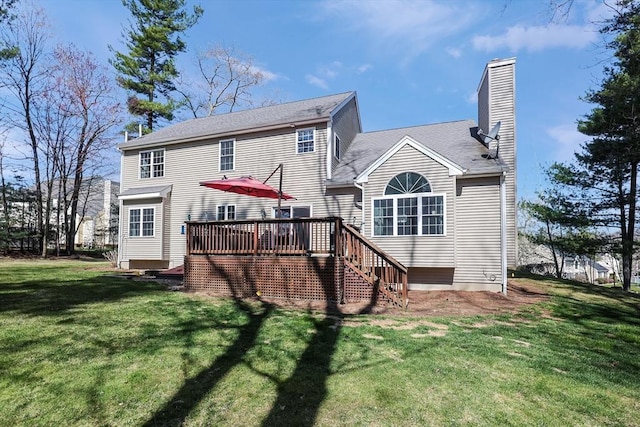 back of property with a chimney, a lawn, stairs, and a deck