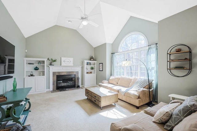living area with light colored carpet, a ceiling fan, lofted ceiling, and a fireplace