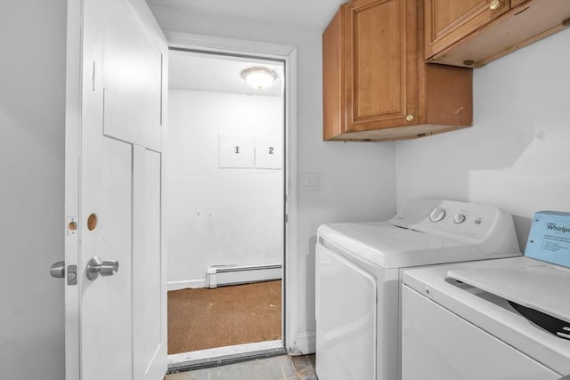 clothes washing area with cabinets, a baseboard heating unit, and washing machine and clothes dryer