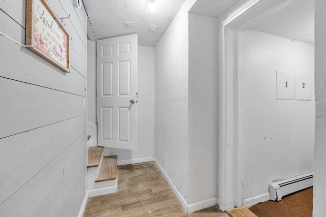 hall featuring light hardwood / wood-style floors and a baseboard heating unit