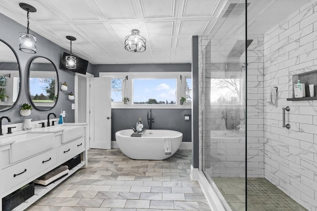 bathroom with vanity and shower with separate bathtub