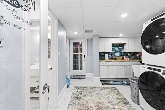 laundry area with stacked washer / dryer