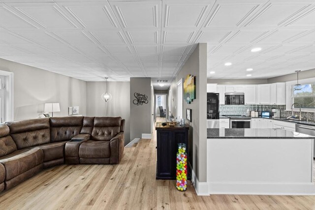 living room with sink and light hardwood / wood-style flooring