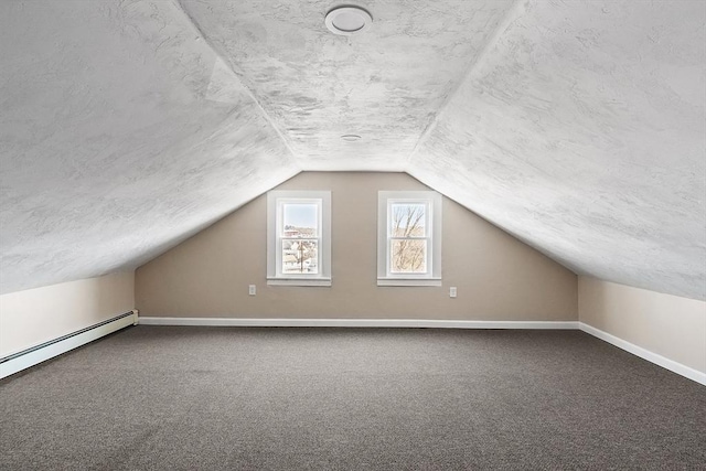 bonus room with a textured ceiling, baseboards, and carpet floors