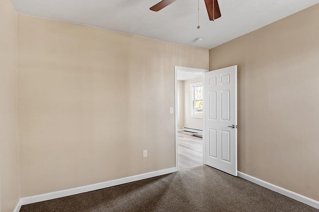 empty room featuring baseboard heating, baseboards, carpet floors, and ceiling fan