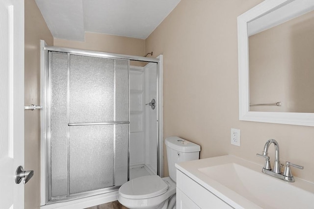 full bath with vanity, toilet, and a shower stall