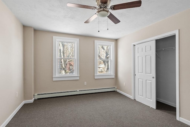 unfurnished bedroom featuring a baseboard radiator, carpet floors, and baseboards